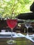 Macro photo with a decorative background of a glass of red wine on a blurry background of an open summer cafe