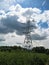 Macro photo with decorative background of high-voltage tower and transmitting wires on a summer day