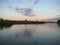 Macro photo with decorative background of rural sunset landscape on the river in beautiful gentle evening shades of light