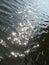 Macro photo with a decorative background of sunbeams on the water of a rural river