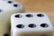 Macro photo of dice with 6 points and second die in the background