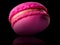 Macro photo of french pink rose macaroon with reflection isolated on black