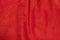 Macro photo of genuine leather with a fold. Red background with natural suede