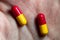 Macro photo of medicine in human hand, pill capsule