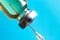 Macro photo needle syringe and medical antibiotic medicine on a blue background. The concept of vaccination in health care, the