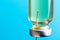 Macro photo needle syringe and medical antibiotic medicine on a blue background. The concept of vaccination in health care, the