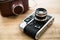 Macro photo of retro manual camera and leather case on table