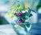 Macro photo of a transparent round vase with flowers