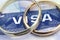 Macro photo of US entry visa sticker in a passport and a couple of rings. Conceptual photo for immigration. Selective focus