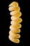Macro photo of yellow fusilli pasta  on black with clipping path