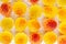 Macro photography of jelly-like craft marmalade with orange juice. The sweetness of yellow and orange jelly candies on a light