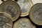 Macro Photography to a pile of Colombian coins over black background.