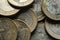 Macro Photography to a pile of Colombian coins over black background.