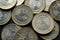 Macro Photography to a pile of Colombian coins over black background.