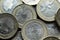 Macro Photography to a pile of Colombian coins over black background.