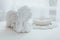 Macro photography of white porcelain figurine of angel lying on table.
