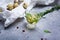 Macro picture of quail eggs and olive oil with rosemary on a gray stone background. Fresh food products.