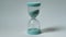 Macro portrait an hourglass on a blurred background. Time lapse time is fleeting