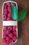 Macro raspberries in a basket with green leaf