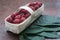 Macro raspberries in a basket with leaf