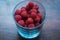 Macro raspberries in glass, with blue filter