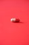 Macro of red capsules on red background. Copy space. Bunch of drugs, cold flu treatment. Coronavirus Covid-19.