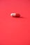 Macro of red capsules on red background. Copy space. Bunch of drugs, cold flu treatment. Coronavirus Covid-19.