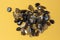 Macro shooting of collection natural rock set of morion, smoky quartz gem mineral stones on yellow background