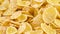 Macro shooting of a pile of corn flakes rotating on the turntable. Isolated on white color background.