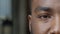 Macro shot of african american man showing one eye on camera