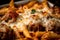 Macro Shot of Baked Ziti with Meatballs and Parmesan Cheese on Top