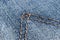 Macro shot Blue jeans fabric texture background with brown stitching. Denim jeans texture. Closeup texture and pattern of jeans