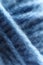 Macro shot of a blue wool yarn background.