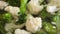 Macro shot of boiling cauliflower and broccoli in pot with hot water. Concept of healthy eating, organic food, vegan.