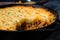 Macro shot of bubbling hot Shepherd pie in a cast-iron skillet straight from the oven, with a crispy golden crust