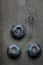 A macro shot of a bunch of blueberries on a dark vintage slate