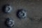 A macro shot of a bunch of blueberries on a dark vintage slate o