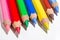 Macro shot of Colorful pencils laying together on a white background