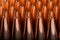 Macro shot of copper bullets that are in many rows