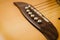 Macro shot down the fretboard of acoustic guitar with shallow depth of field