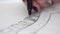 Macro shot of drawing new design of a shoes. Workplace of shoe designer. Pencil drawing a shoe design on a paper at his