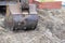 Macro shot of an excavator bucket on the ground / earthmoving machinery