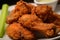 macro shot of a fried chicken wing with a crunchy, well-seasoned coating and a moist and flavorful interior