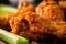 macro shot of a fried chicken wing with a crunchy, well-seasoned coating and a moist and flavorful interior