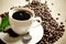 Macro shot of frothy coffee with green leaf on linen cloth