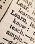 Macro shot of `Learn` in a dictionary page