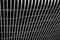 Macro shot of metal mesh in front of a black surface