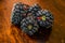 Macro shot of organic , fresh and healthy blackberry , blackberries on a wooden brown background