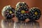 Macro shot of organic , fresh  and healthy blackberry , blackberries on a wooden brown background