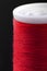 Macro shot of red bobbin thread isoladed on black